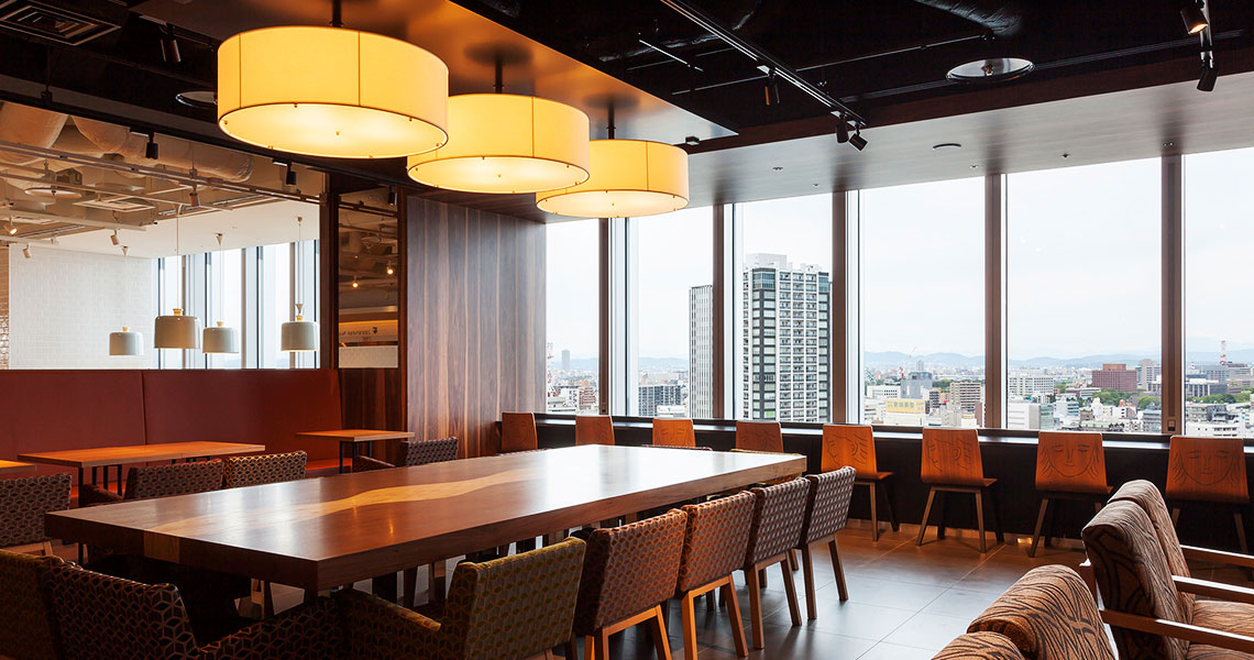 tower view in dimly lit room with tables and chairs overlooking skyline